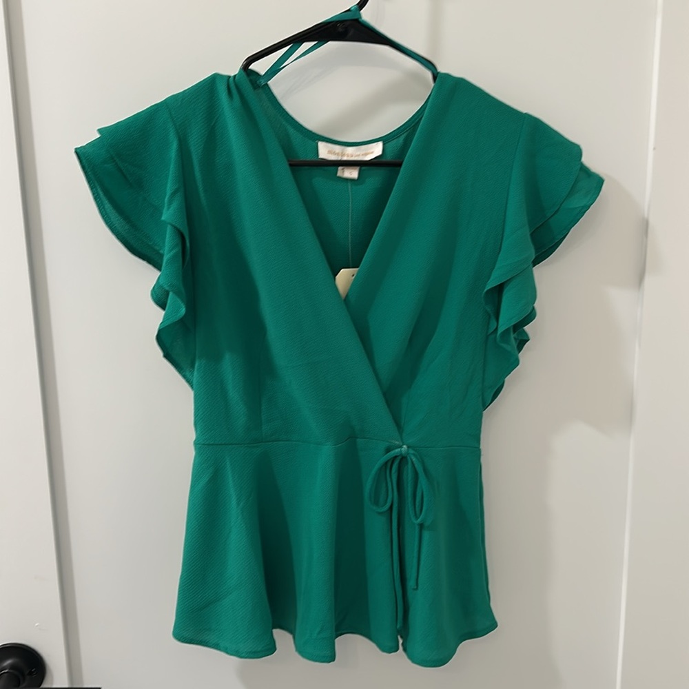 Pretty green, wrap tie top in lightweight fabric. Never worn.